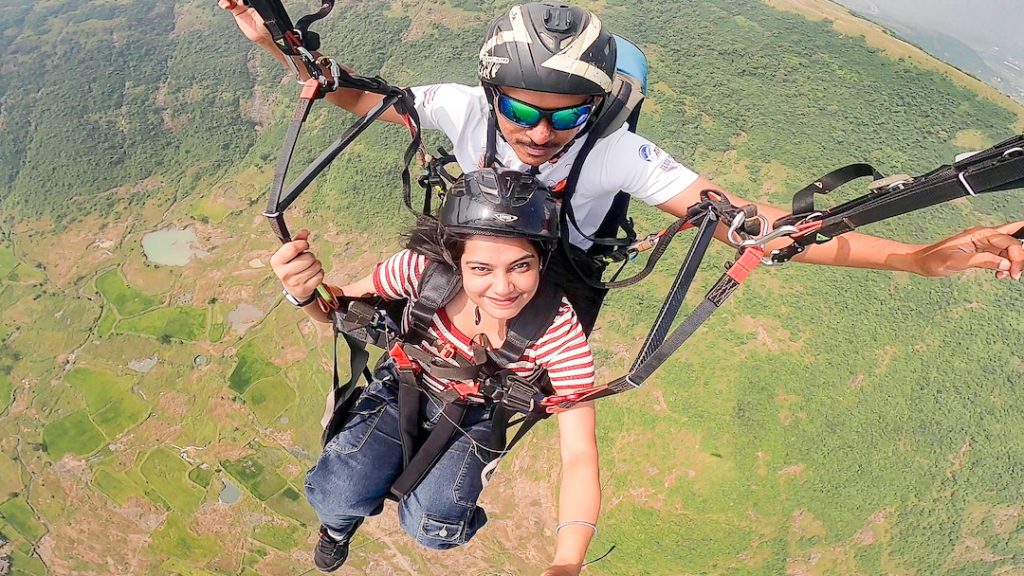 nstructor and passenger sharing smiles while gliding over the beautiful valleys of Kamshet.